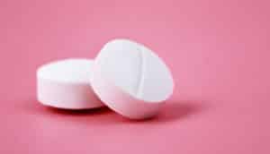white pills on pink (liver cancer concept)