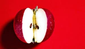 cut apple on red (proteins concept)