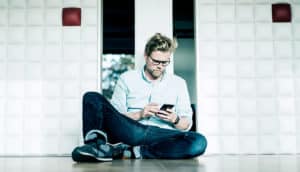 man reading phone (fact check concept)