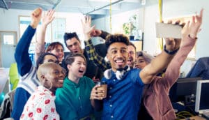 coworkers take a group selfie