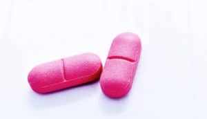 two pink pills (gut bacteria concept)