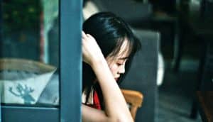 young woman looking down (PTSD concept)