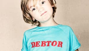 kid with "debtor" on shirt