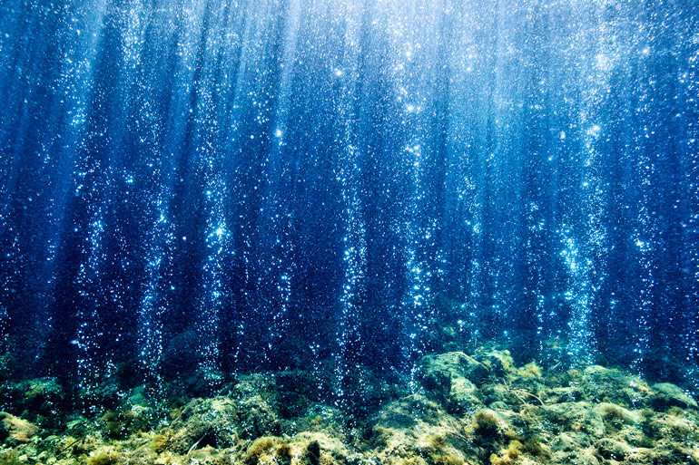 Volcanic carbon dioxide seeps from the ocean floor near Ischia, Italy.