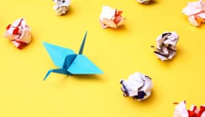 paper crane and crumpled paper (misfolded proteins concept)