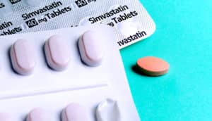 statin pill packs on teal (Statins concept)