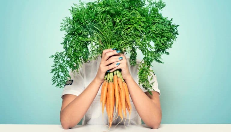 carrots in front of face