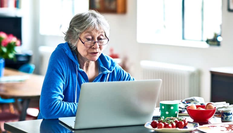 older woman looking at lap top