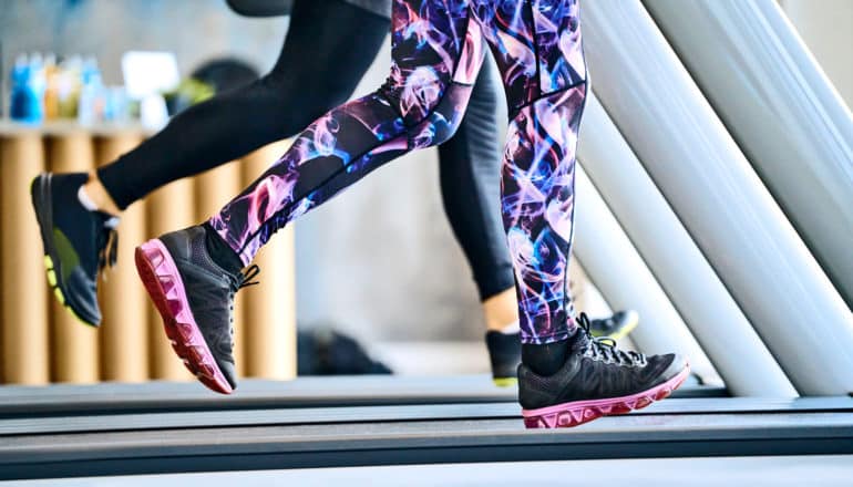 legs of people running on treadmills