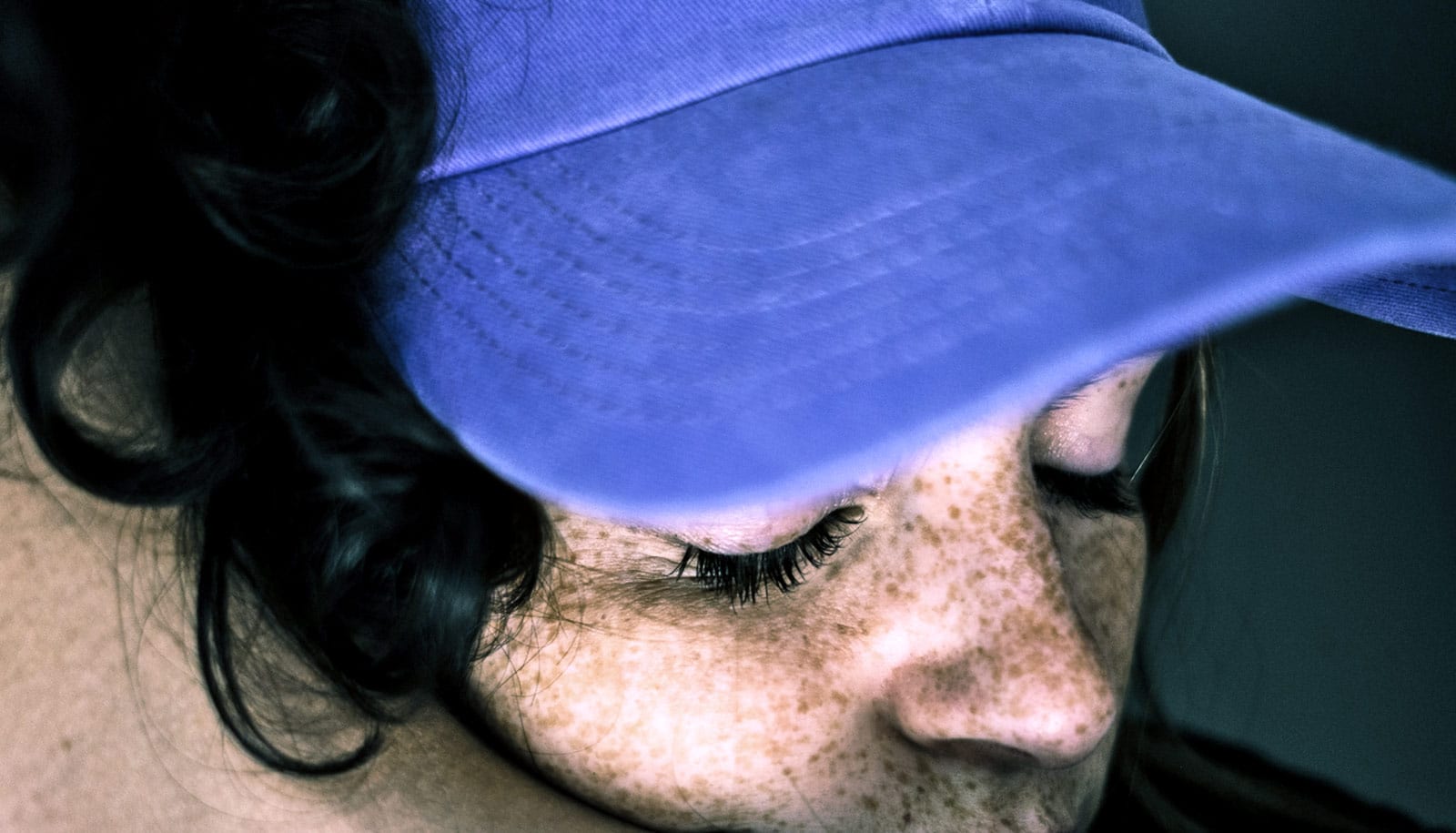 teen girl gets hug in blue baseball cap
