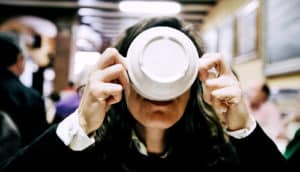 woman drinking from bowl