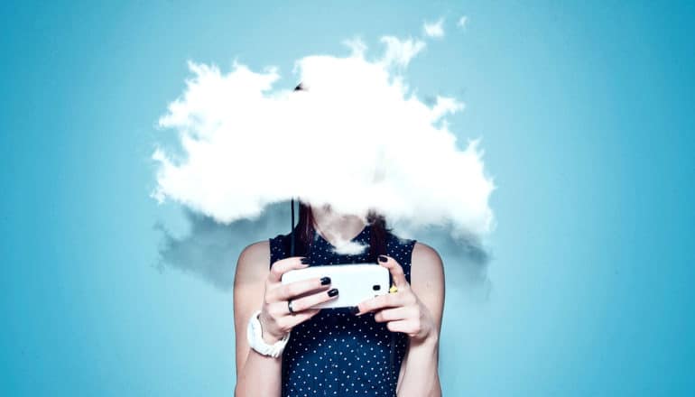 woman looking at phone in fog (sponsored content concept)