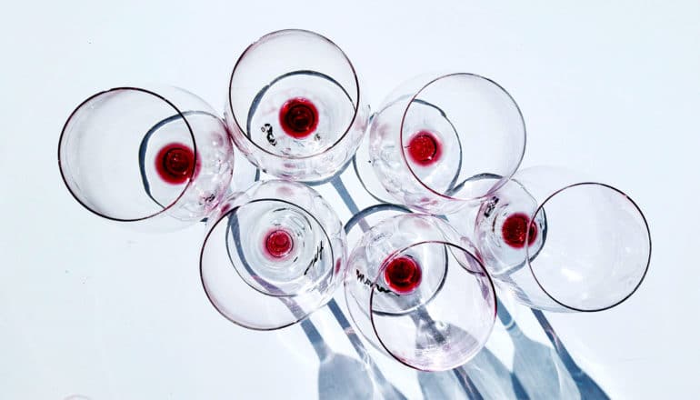 six empty wine glasses - overdrinking