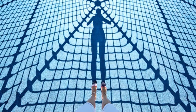 shadow of figure and net on blue