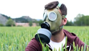 gas mask man in field (Roundup concept)