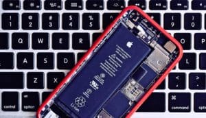 battery in open iPhone on keyboard