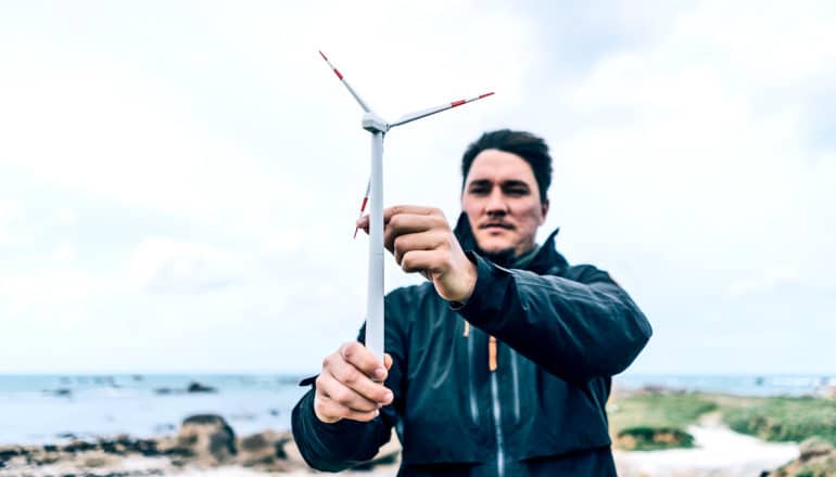 man holding mini wind turbine