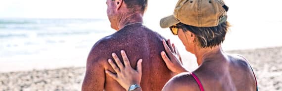 older couple applying sunscreen