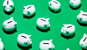piggy banks on green (saving money concept)