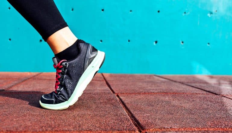 shoe walking against blue wall (concussion concept)