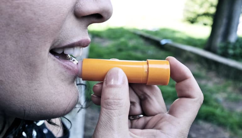 woman using chapstick