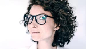 woman with glasses and curly hair (brains concept)