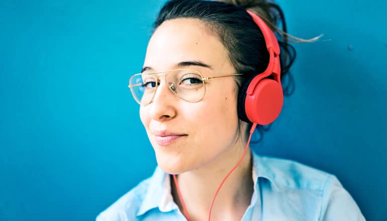 young woman with red headphones