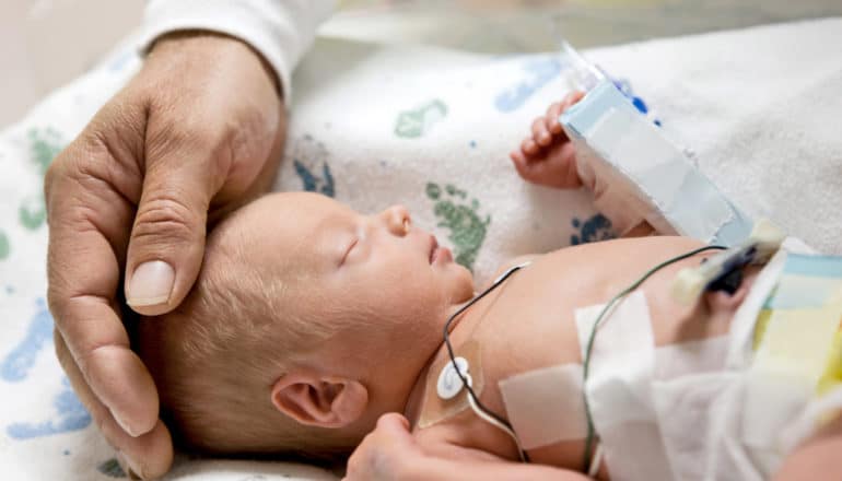 newborn baby with sensors attached