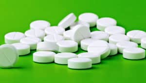 aspirin on green background