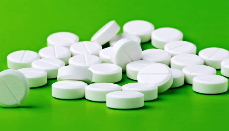 aspirin on green background