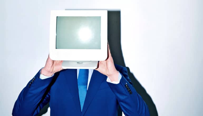 man holding monitor in front of face (artificial intelligence concept)