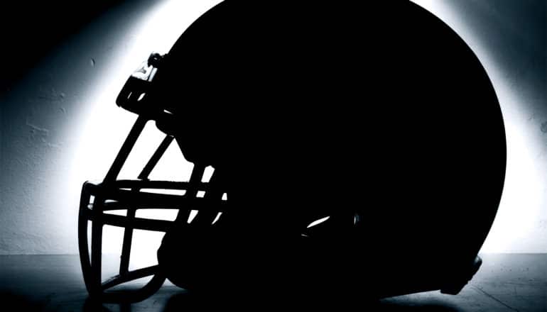 football helmet silhouette (concussions symptoms concept)