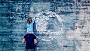 girl on dads shoulder drawing globe