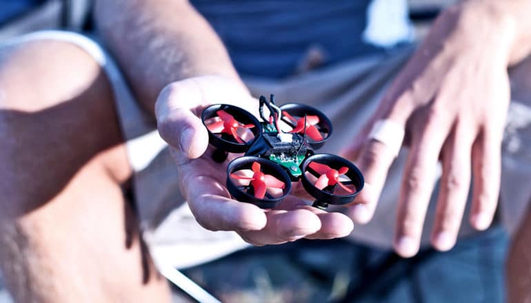 holding small drone
