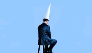 man sitting in dunce hat (artificial intelligence concept)
