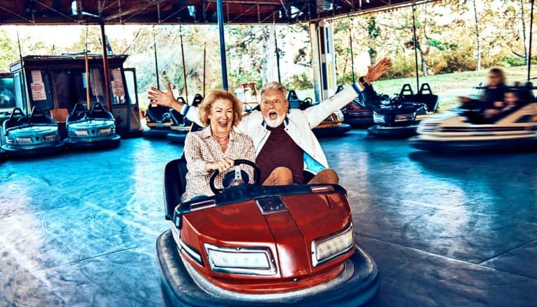 older couple in bumper car (marriage concept)