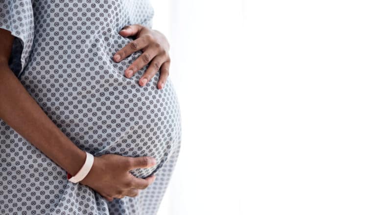 pregnant woman in hospital gown