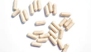 probiotics - beige capsules on white