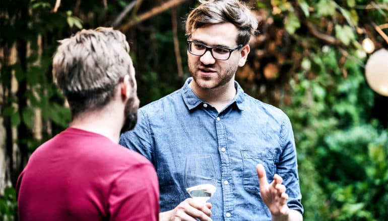 red and blue shirted men talking