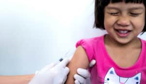 girl smiles with eyes shut before shot