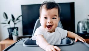 smiling baby in high chair