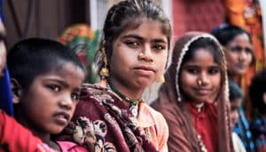 Indian girl in group looks at camera