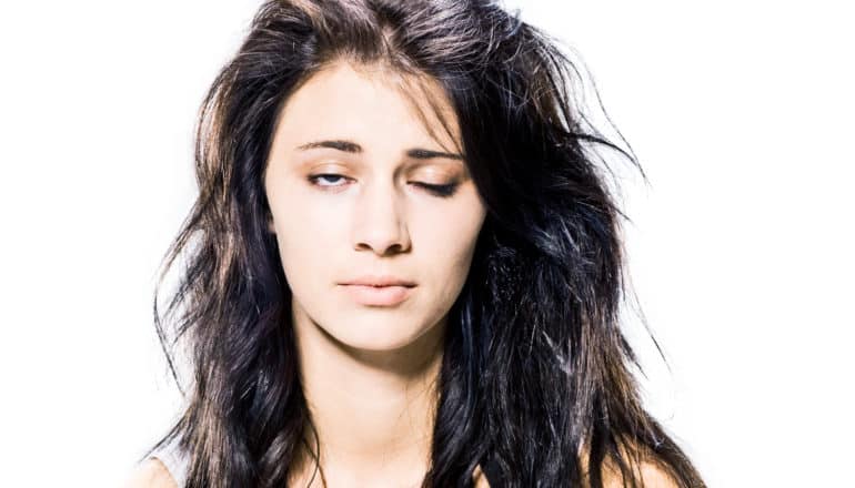 tired woman with one eye closed