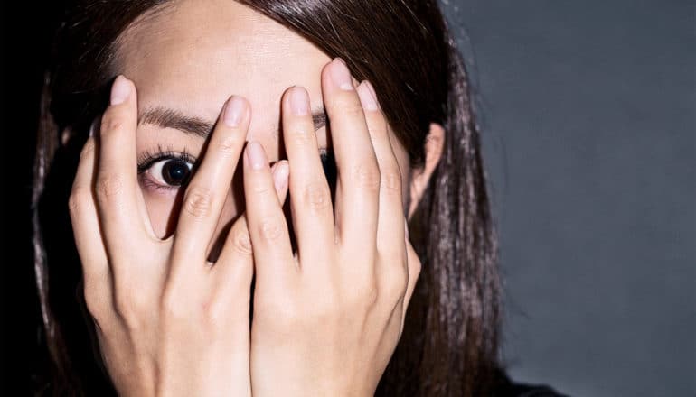 woman covering face