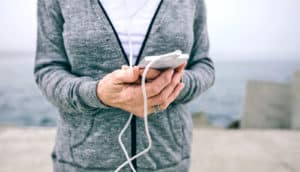 woman holds phone in hands