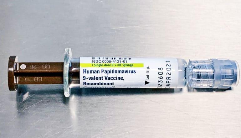 HPV vaccine syringe on metal table