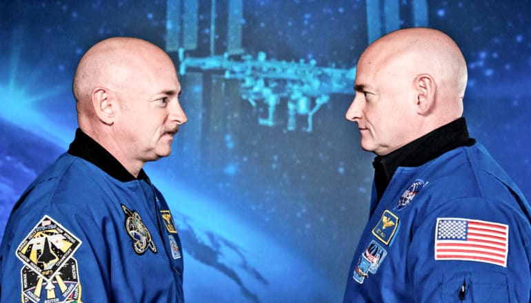 astronauts Mark Kelly and Scott Kelly stand face to face