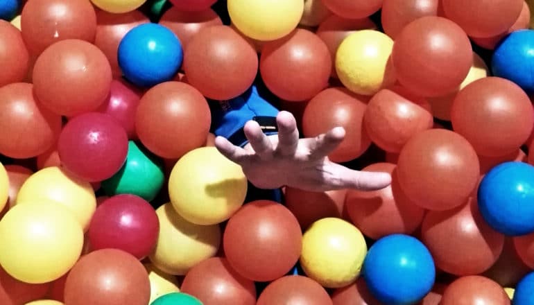 hand coming out of plastic ball pit