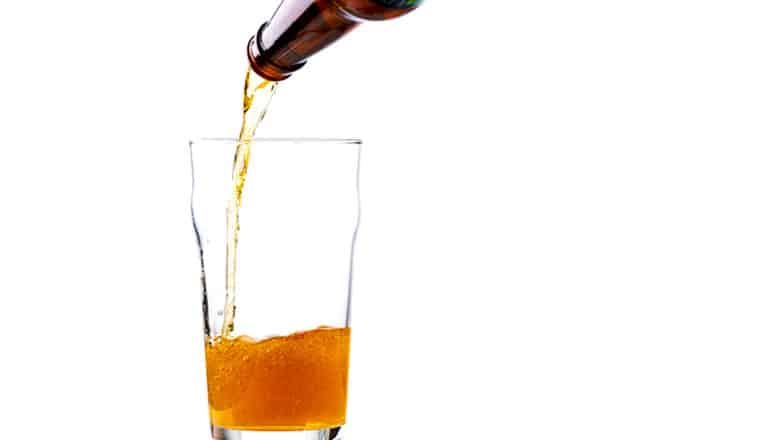 beer pouring into glass on white