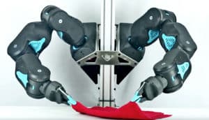 Blue robot arms folding laundry